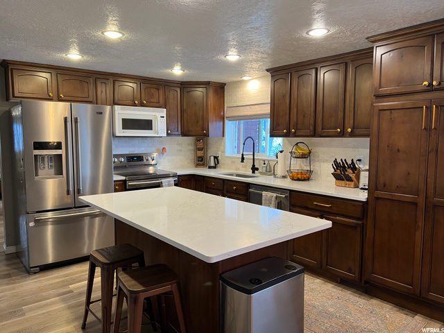 Kitchen w/ old microwave and and stove