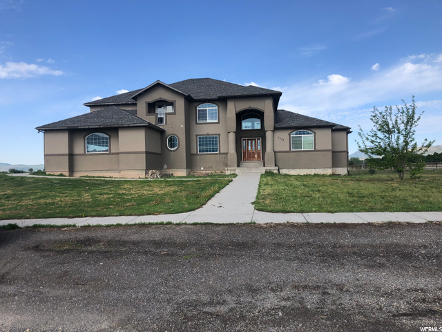 Come see this diamond in the rough! Very large, custom, luxury home boasting 8000+ square feet on 3.42 acres in one of the most beautiful areas of Cache Valley. The foyer, main family room, and rock fireplace are all two stories high. This home also has 2 huge family rooms, 3 offices/dens and 10 bedrooms; all with spacious, walk-in closets. The full bathrooms include ample dressing room/sink areas with separate bath/shower and toilet rooms.  In the master suite there are two big walk-in closets, a corner, jetted tub and an oversized shower room. If you are looking for storage, this is the place for you with an enormous pantry, two impressive cold storage rooms, another bonus room with a closet and a massive space for a future theater or workshop under the 3 car garage. Enjoy amazing 360 degree mountain views from the second level balconies (one on the east and one on the west) and the main level deck, which extends off the kitchen and includes a connected gas BBQ grill. There's plenty to do with the in-ground trampoline, playset, swings, hammock posts, basketball hoop and fire pit. Animal lovers paradise with pig (or other pet) pens, enormous 2 room chicken coop with storage, 40x50 ft custom dog kennel, and fully fenced horse pasture with animal shelter, tack shed, and hay/rv cover.  Garage is plumbed for a shower and drinking fountain.  With a little TLC, this once in a lifetime opportunity can become your dream come true forever home!  Square footage and details provided as a courtesy - Buyer/Buyer's Agent to verify all.