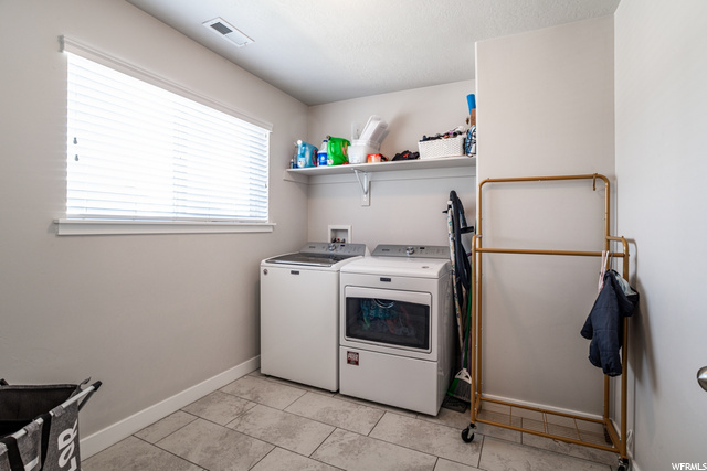 Washroom with natural light and separate washer and dryer