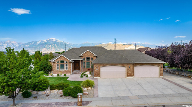 Single story home featuring garage and a mountain view