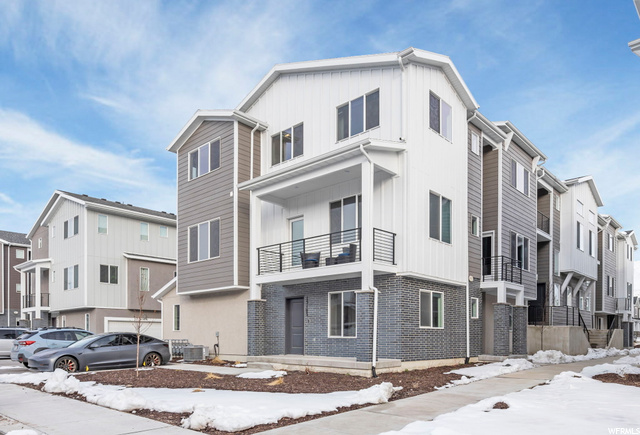 Snow covered building featuring central AC unit