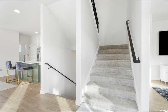 Staircase with light parquet floors