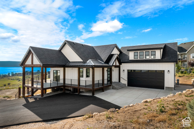 View of front of house with covered porch and a water view