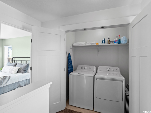 Laundry room with light carpet, independent washer and dryer, and washer / clothes dryer