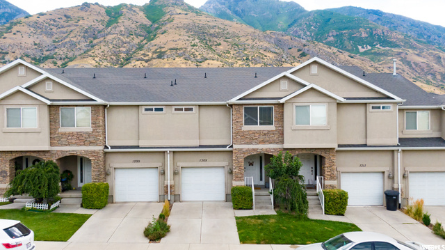 Townhome / multi-family property with a mountain view and garage