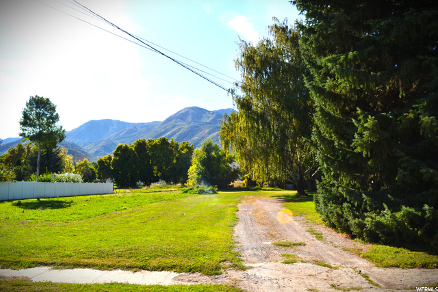 241 S CENTER ST Wellsville, Utah Amazing opportunity to own a piece of downtown Wellsville! Almost two full acres of land with beautiful breathtaking views of the Wellsville mountains. Mature trees with a share of irrigation water. Sale includes 2 separate tax ID parcels. The opportunities are endless. Revive and bring out the character of the old farmhouse or start new on this private piece of paradise and enjoy everything the community of Wellsville has to offer. Buyer to verify all information. The Sale of property and house are "as is" and together.