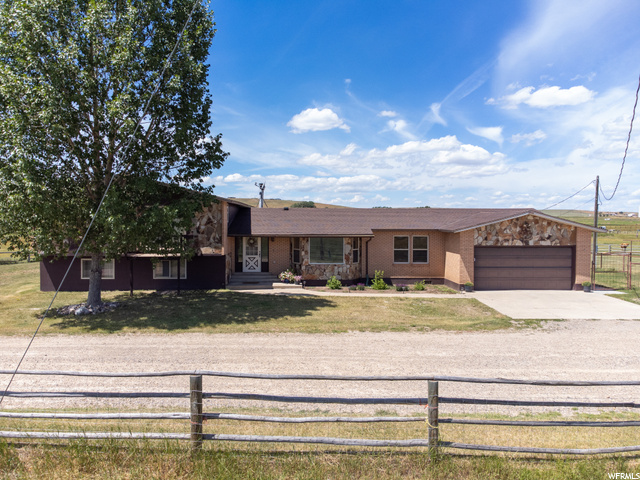 Don't miss this amazing home located on 35 acres in Bear River! This 3,448 sq ft home has 6 bedrooms, 3.25 bathrooms, an updated kitchen with stainless steel appliances including a double oven, two spacious living rooms, a wood burning stove, main level laundry, and a spacious master suite with a large walk-in closet. Enjoy the spectacular views off the back deck which opens up to the open flat backyard. Each room has amazing views of the surrounding pastures. There is plenty of space outside for toys, animals, and outdoor activities. The recently constructed 2,400 sq ft barn has a large tac room, lots of space for new corrals in the barn, and a water hydrant. The 50' x 80' red iron shop which has heat, three 14' doors, and one 12' door is perfect for any storage or hobbies. The entire property is fenced with three separate pastures. There are two RV spots with electrical and sewer hookups, a large chicken coop that has power, and an irrigation ditch that runs through the property.