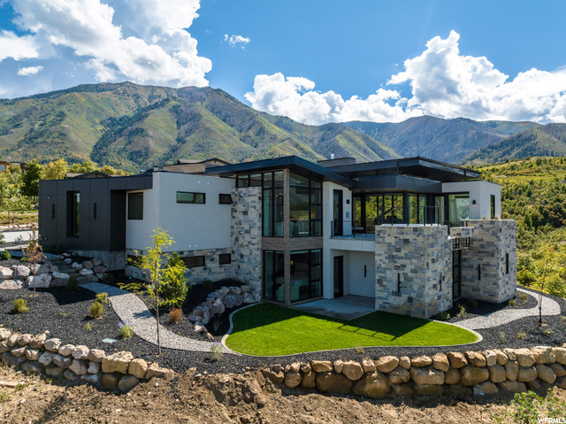 Experience the pinnacle of luxury living in this exceptional custom mountain modern home, set on a premium lot that gifts you with unobstructed, forever views of the mountains and the sprawling valley below. No detail has been spared in crafting this masterpiece, offering a lifestyle that blends opulence, convenience, and awe-inspiring natural beauty. Here are a few of the many features of this home- Elevator Convenience: Enjoy the ease of access with an elevator that spans the upper and lower level, ensuring comfort and accessibility for all. Gourmet Chef's Kitchen: A spacious, upgraded chef's kitchen with Monogram appliances, white oak cabinets, quartz counter tops & floating shelf space. two dishwashers, and a large butler's pantry featuring a convenient Costco door. Outdoor Oasis: Unwind in style with a hot tub and a remote-controlled fireplace, on the upper deck, where you'll be captivated by panoramic valley views. Smart Home Integration: This home is thoughtfully wired for a smart living experience, putting lighting, security, and climate control at your fingertips. Floor-to-Ceiling Wonder: Floor-to-ceiling windows grace every room, framing the spectacular mountain and valley vistas, ensuring that nature's beauty is never out of sight. Downstairs Sanctuary: The lower level offers a self-contained haven with its own separate kitchen, laundry, family room, huge storage area and three bedrooms, each with attached bathrooms. Step out onto a lower patio and be mesmerized by the breathtaking views. Ample Garage Space: Park your vehicles with ease in the generous 4-car garage, offering extra height, heated flooring and electric charging outlet. Exquisite Details: Every corner of this home exudes elegance and craftsmanship from the flooring to the lighting and every little detail in between. Fully Furnished: You'll find this mountain haven fully furnished, inside and out. Your turnkey living experience begins the moment you walk through the door. This mountain modern masterpiece is truly a rare find, offering a haven for those who want the perfect blend of luxury and the breathtaking beauty of nature. Every inch of this home has been thoughtfully designed to provide a lifestyle that epitomizes comfort, elegance, and unbeatable views. There is a feature list attached to the listing! The vacant lot adjacent to this home is also available if you want even more privacy! The pricing on this home comes with it fully furnished inside and out! If the buyer dose not want the furnishings, the asking price will be adjusted.