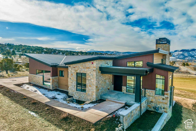 Rear view of house featuring a mountain view