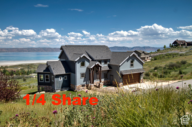 View of front of home with a water and mountain view