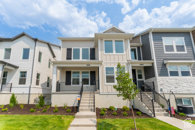 Multi unit property with a porch and central air condition unit