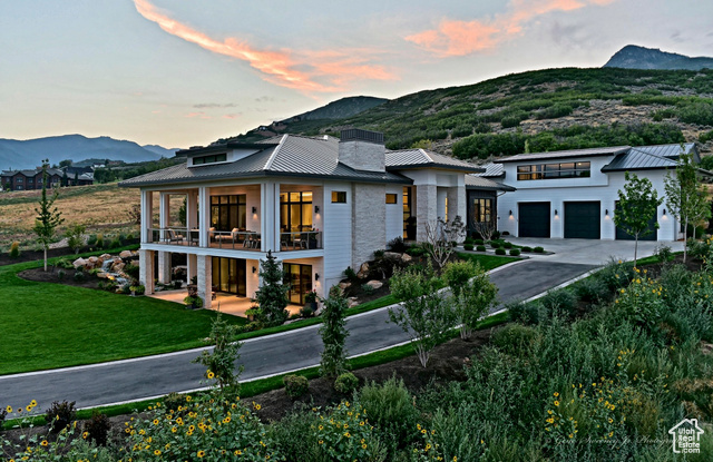 This magnificent residence is perfectly nestled in the northern foothills of the Midway valley and allows convenient access to year-round adventures in the 10,000 acre Wasatch State Park, which boasts 30 miles of hiking, biking and nature trails in which to relish.  The home is thoughtfully situated to maximize stunning views of the Heber Valley, surrounding views of Snake Creek and Huber Peak to the North.  This majestic property provides a backdrop of mature landscaping enveloping a private fire pit, a zip-line, in-ground trampoline and a robust water feature that brings the tranquil sounds of a mountain stream to be enjoyed on the expansive decks, interior gathering spaces, lower level suite and the grand Owner's Suite. This exquisitely crafted Prairie designed home fits seamlessly into the rural Midway surroundings while offering everything that could be desired in the timelessly appointed interior space.  From being bathed in natural light upon entry and throughout this open concept plan, to a breathtaking Kitchen with Thermador appliances, a Grand Pantry and Butler's Pantry, 5 generously sized bedrooms all with ensuite baths, 2 powder baths, an exciting kids' hangout, lower and upper level gathering spaces, video room and hidden playroom, this home has plenty of space to relax and unwind or host gatherings filled with family and friends.  This home truly has it all!  Some notable architectural elements that adorn the home include 10' tall window and glass openings, double quad sliders leading to the spacious deck and lower patio, 12' ceilings with LED floating coffers and lighted coves. Sophisticated cabinetry, fireplace detailing and expertly designed interior elements become the focal point of each meticulously detailed space.  Other notable highlights include an oversized 3-car garage with interior workshop, whole house fan, 1,000 gallon water storage tank, automated lighting and motorized rollershades. Don't miss your chance to own this one-of-a-kind dream home and experience the best of mountain living.