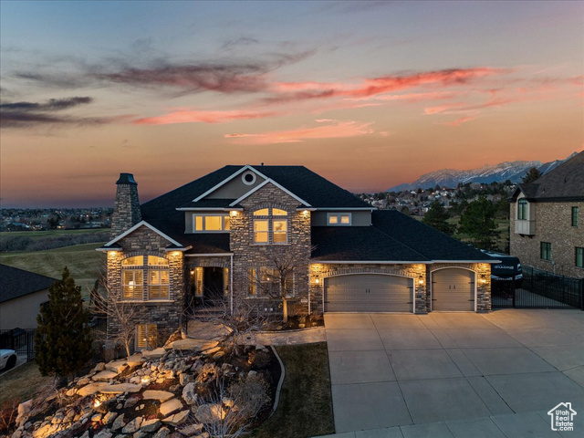 This home is currently empty and move in ready. This meticulously renovated home sits at the top of a quiet cul-de-sac in a coveted Draper neighborhood at the base of the Wasatch mountains. Nestled against a private golf course, this home offers gorgeous mountain views and feels as though your backyard is a nature preserve.  A stream welcomes birds and deer as you walk inside. The bright entrance features soaring 20 foot ceilings and modern staircase. The home was remodeled in 2021 and 2023 with designer lighting, hardware, fixtures, carpet, stone and quartz countertops, wood flooring and custom touches throughout. The heart of the home is an open great room with beautiful fireplace, leading seamlessly to a spacious kitchen with ample cabinets and counter space. A covered trex deck off the kitchen is ideal for outdoor entertaining with built-in speakers, sun shades and gas connection for grilling. Enjoy180 degree unobstructed views of the valley, sunsets and sunrises over the mountains. Stroll the professionally landscaped yard to a gas fire pit and gazebo next to a tranquil waterfall. A second, walk-out patio is the perfect place to relax after soaking in the hot tub.  The main bedroom features a floor to ceiling marble wall showcasing a 72" gas fireplace, vaulted ceiling with wood beams and private views. A large spa-like ensuite is a retreat of it's own, complete with a walk-in rainfall shower with body sprays, soaking tub and a massive closet with oversized island. The elegant basement was custom designed to be an entertainers dream. Featuring a sommelier, pebble ice maker, dishwasher, fridge, freezer, gold sink, glass/brass shelves for displaying glassware, and led lit concession drawers featuring treats for movie night. Color changing led lighting throughout the spacious basement changes the mood depending on the movie theme or sporting event of the evening! A personal home theater boasts 13 reclining seats, a dedicated AC unit and smart lighting. The home has a large gym with high ceilings so it could easily be transformed into a personal golf simulator. Additional upgrades include Sono's speakers throughout, new roof in 2023, security camera system, Nest thermostats, tankless water heater (new in 2023), water softener, smart irrigation system, wifi 6 access points, CAT 6 wiring, Smart Lutron switches to run lights remotely and set up day and night scenes. Oversized 4-car garage with extra room for your boat or ATV, plus an additional gated RV parking space.    https://my.matterport.com/show/?m=VTAmxwLHaKB  Square footage figures are provided as a courtesy estimate only and were obtained from County Records.  Buyer is advised to obtain an independent measurement.