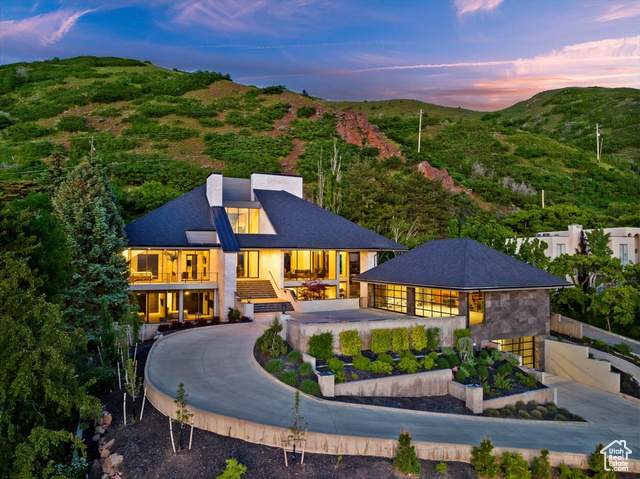 House at dusk featuring a mountain view