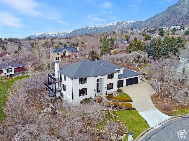 Welcome to this stunning home nestled on Sandy's East Bench, where luxury meets comfort on a serene 1/2 acre lot tucked away in a quiet cul-de-sac. This remarkable property offers unparalleled access to nature with world-class ski resorts, recreational facilities, golfing, biking, and hiking trails within reach of the majestic Wasatch Mountains at your doorstep. Step inside to relax and re-juvinate in this renovated home that seamlessly combines modern convenience with timeless elegance, enhanced with quality craftsmanship and attention to detail.   The main floor bedroom with adjoining  bathroom offers multiple options and is currently being used as a home office. The heart of this home is the gourmet kitchen, featuring exquisite granite countertops, built in ice maker, a Wolf stove, and double ovens, perfect for culinary enthusiasts and entertainers alike. Whether hosting intimate gatherings or preparing family meals, this kitchen is sure to inspire creativity and delight. Just step outside your kitchen eating area and enjoy outdoor bbq's while soaking in the beautiful mountain views from your newly built large deck. Retreat to the luxurious primary bedroom suite, where relaxation awaits. Enjoy Spectacular Mountain and Valley Views off your own private deck, a cozy fireplace, and a spa-like bathroom boasting heated floors, marble accents, an oversized shower, a soaking tub, and a soapstone countertop. Melt away the stresses of the day in this serene sanctuary. This Second level also boasts three additional bedrooms. Venture downstairs to discover a full walkout lower level with a separate entrance, offering an apartment-style living space complete with a full kitchen, family/game room, two bedrooms, a full bath,  which adds convenience and versatility, ideal for guests or extended family members. With an oversized garage thats spacious enough for four cars, additional storage space and electric car charging station , this home effortlessly combines functionality with style. Whether you're a car enthusiast or simply appreciate ample storage options, this garage is sure to impress with exterior space for additional RV Parking Don't miss your chance to call this extraordinary property home, your own.  Square footage has been provided as a courtesy, Buyer and Buyers Agent to verify all information.