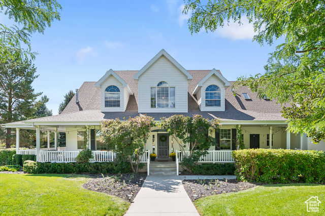 View of front of property with a front lawn and a porch