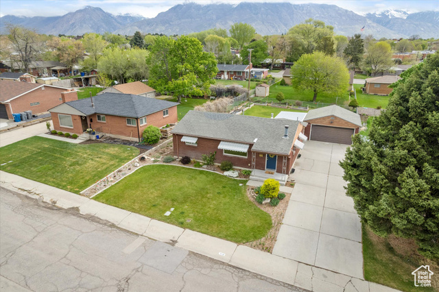 Beautiful urban homestead on a quiet street in the heart of American Fork near parks, schools, restaurants, and shopping at The Meadows! The spacious living area features hardwood floors and large windows, creating an inviting atmosphere for relaxation or entertaining guests. The large, fenced backyard with a covered patio and raised bed gardens is chicken- friendly! The kitchen is perfect for preparing farm-to-table meals sourced from your own backyard!  The full basement is great for a cool retreat in the summer and woodstove warmth in the winter. Buyer to verify information.