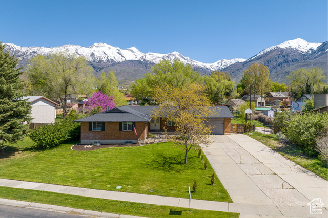 OPEN HOUSE Saturday 5/4: 11-1! This charming Alpine rambler with breathtaking views of the Wasatch Mountain Range, provides a picturesque backdrop to your everyday life. Sitting on a HUGE 3/4 acre lot, the property offers ample space and a wide array of uses. A dedicated garden area, with producing fruit trees, is the perfect place to start your homestead. Plus the lot is large enough and zoned to allow for up to 3 large animals and 6 chickens, making for suburban farming at it's finest. As you step inside, you'll be greeted by a spacious interior that effortlessly blends comfort and functionality. The remodeled kitchen features granite counter tops, real wood cabinets, and newer stainless steel appliances (fridge included). The kitchen opens directly to a large covered patio with stunning mountain views, a wonderful place to host summer get-togethers. With three full bathrooms, and four large bedrooms, including a an oversized primary suite; with walk in closet, there's plenty of room for the whole family to spread out and unwind. The dedicated den is one of the best rooms in the house, with floor to ceiling windows and the same mountain views. The basement, with separate entrance, previously included a second kitchen that could easily be converted back into a kitchen, allowing for a mother in law apartment and possible income to offset your mortgage payment. The appliances, AC, and furnace were all recently replaced, making for low costs of ownership. Located on a quiet street but with easy access to shopping, dining and wonderful trail access, this sleepy location can't be beat. This home offers a rare opportunity to create your own homestead in the heart of Alpine. Square footage figures are provided as a courtesy estimate only and were obtained from appraisal. Buyer and buyer's agent to confirm all information contained in listing.