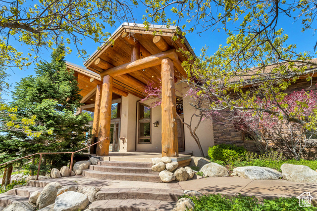 Tucked into the picturesque hills of Alpine, this enchanting Southwest-style 2-story home offers a comforting blend of nature and luxury living. Boasting panoramic 360-degree vistas of the majestic mountain and the surrounding valley and lake, every corner of this home invites you to indulge in the beauty of the outdoors. The grand entrance features stunning wood beams and logs, adorning both the exterior and interior, seamlessly bringing the outdoors inside. Vaulted ceilings and expansive windows offer exclusive views of the serene landscape. The kitchen is equipped with top-of-the-line appliances, including built-in dishwasher, trash compactor, and gas double ovens. Adjacent, the grand semi-formal dining area features built-in shelving and multiple doors leading to the full wrap-around balcony deck, perfect for al fresco dining with a view. The full wrap-around balcony deck has access to it through multiple doors located in every room on the main floor. Retreat to the luxurious Primary Suite, complete with a custom Santa Fe Kiva Fireplace, expansive bathroom with separate jetted tub and shower, and an oversized walk-in closet with built-in cabinetry. Custom-designed for productivity and comfort, the office space boasts cabinetry and desks ideal for remote work or creative endeavors. The basement presents a walk-out entrance to a covered patio and a wet bar, making it an ideal mother-in-law apartment or entertainment haven. Additionally, the basement features a full workshop with shelving and storage allowing for an oasis for your upcoming projects. Completing this exceptional property is the attached 2-car garage with shelving units for storage, along with a built-in oversized 1-car garage beneath the home, offering ample space for vehicles and toys alike. Ample storage space is found throughout the home, including an oversized storage room with built-in shelving, an exterior storage shed, and extra space in both garages. Embrace a lifestyle of luxury and tranquility in this Alpine gem, call us today to schedule a private tour! Buyer/Buyer's Agent to verify all info.