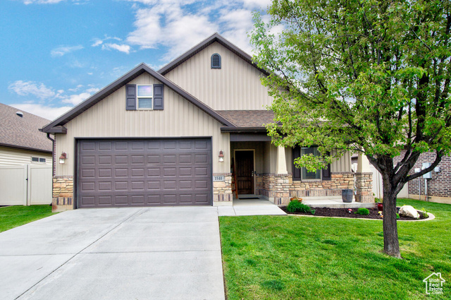 FRONT VIEW AND 2 CAR GARAGE WITH STORAGE SPACE ABOVE GARAGE