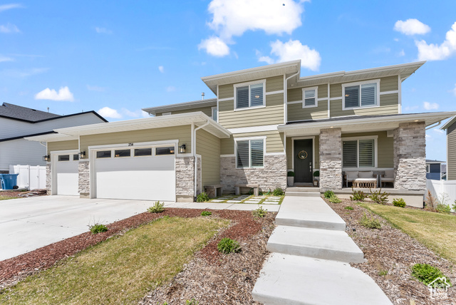 View of front of property with a garage and covered porch