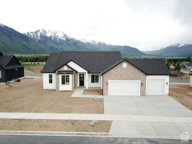 View of front facade featuring a garage and a mountain view