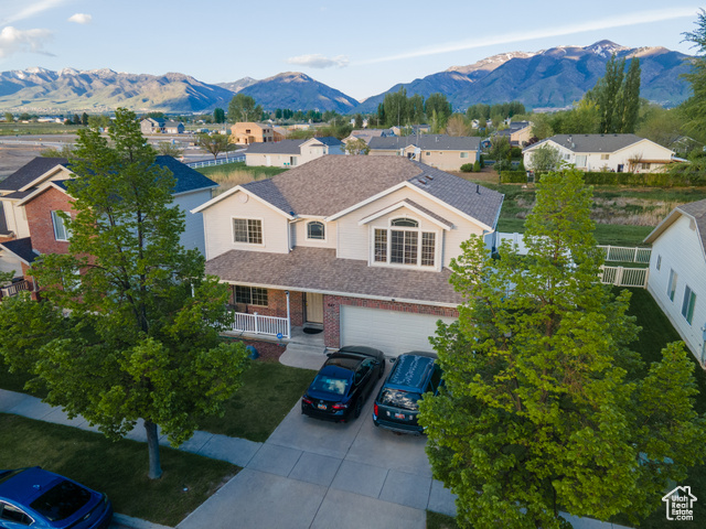 View of front of house with a garage and a mountain view