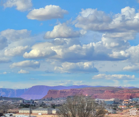 View to the northwest of the red sandstone bluff overlooking St. George with Snow Canyon State Park in the distance.