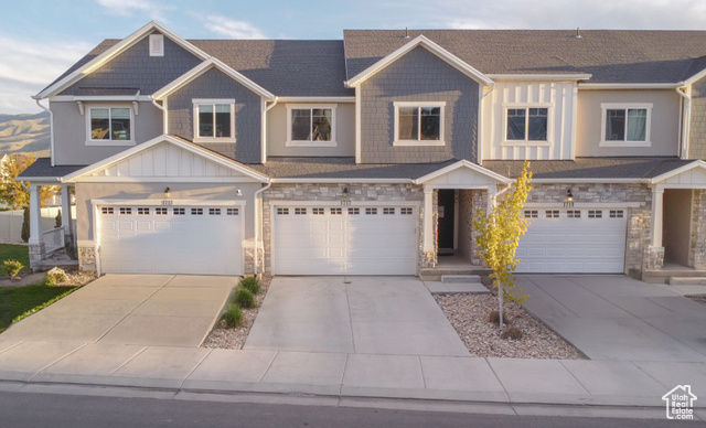 The exterior includes a welcoming front entry, a back patio, and a well-maintained grass area perfect for outdoor enjoyment. Enjoy stunning mountain views from various vantage points, all nestled in a tranquil neighborhood.