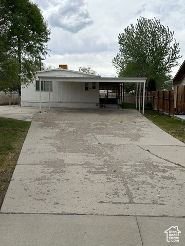 View of front of house with a carport