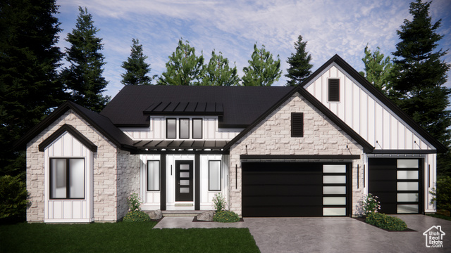 View of front facade with a front lawn and a garage