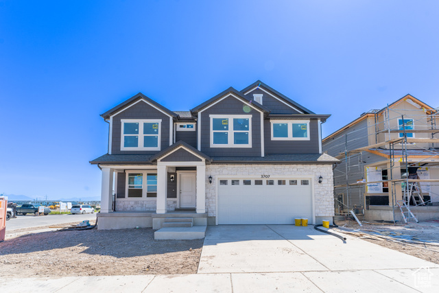 Craftsman house with covered porch and a garage