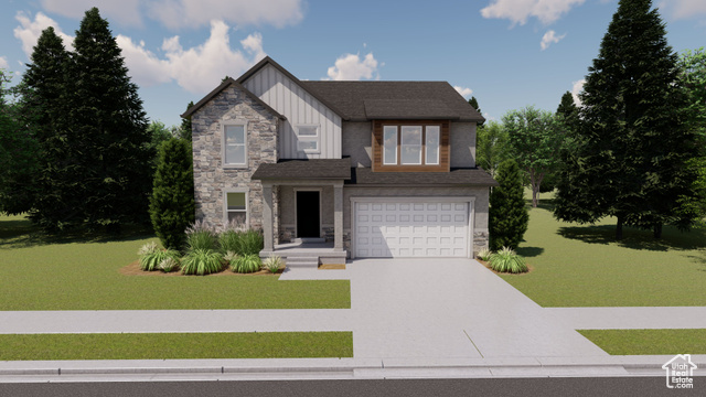 View of front of home with a front yard and a garage