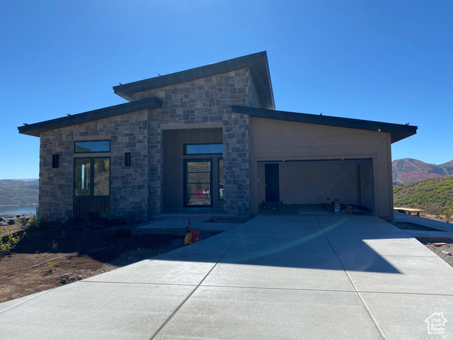 View of front facade with a mountain view and a garage