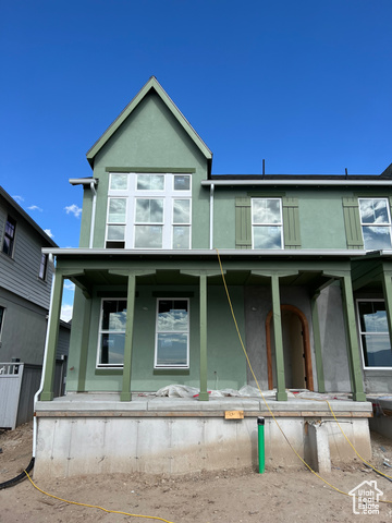 View of front of property with covered porch and arched entryway