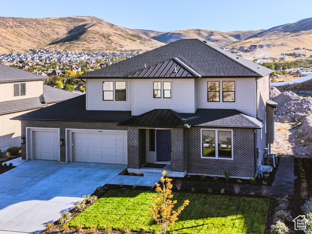 View of front facade featuring a garage and a mountain view