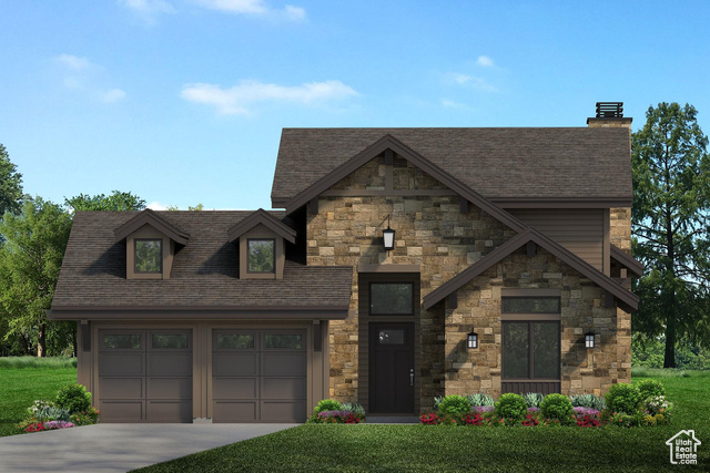 View of front of property featuring a garage and a front yard