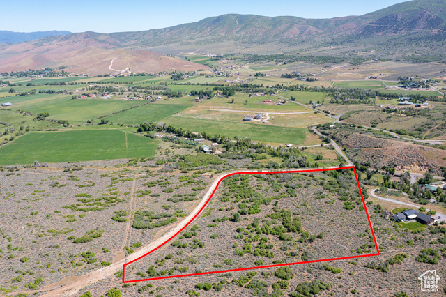 Birds eye view of property with a mountain view and a rural view