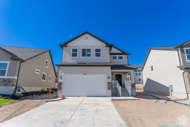 View of front facade featuring a garage