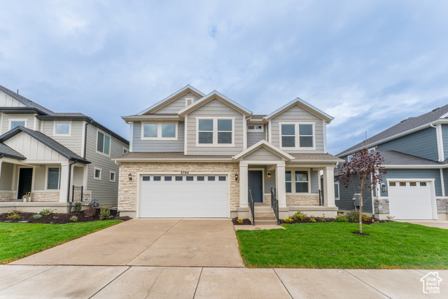 Craftsman house with a porch, a front lawn, and a garage