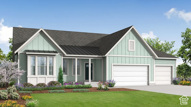 View of front facade with a garage and a front lawn