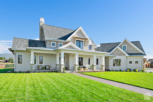 View of front facade with a porch and a front lawn