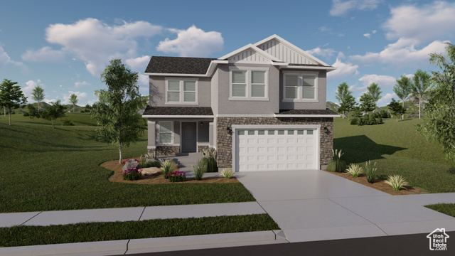 View of front facade featuring a garage and a front lawn