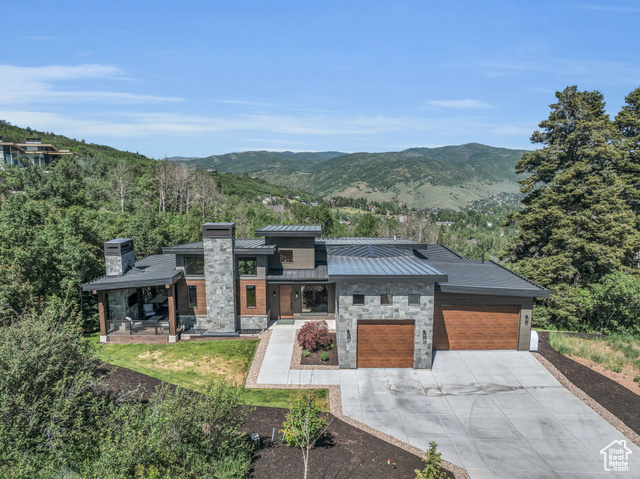 View of front of house with a garage and a mountain view