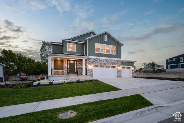 Craftsman house with a yard, a garage, and a porch