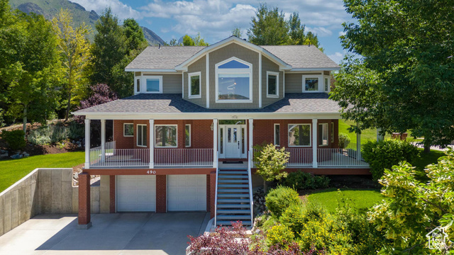 View of front of home featuring a garage and covered porch