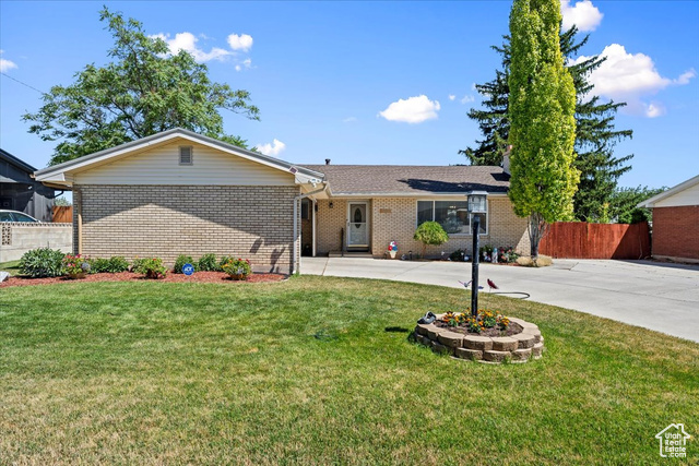 Ranch-style home featuring a front yard