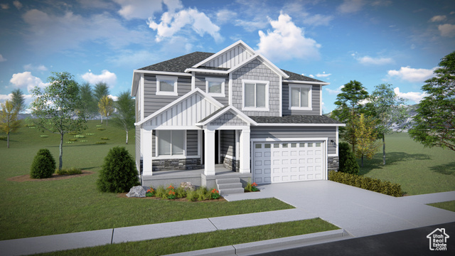 View of front of home with a garage and a front lawn