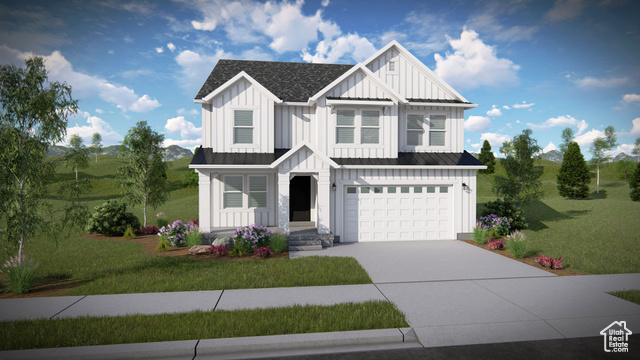 View of front facade with a garage and a front lawn