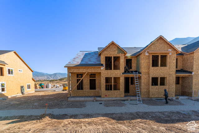 Rear view of house featuring a porch and a mountain view